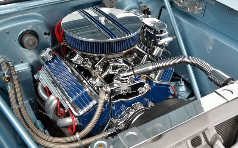 Chrome V8 engine bay close-up showing the mechanical systems automotive engineers design Chrome V8 engine bay close-up showing the mechanical systems automotive engineers design