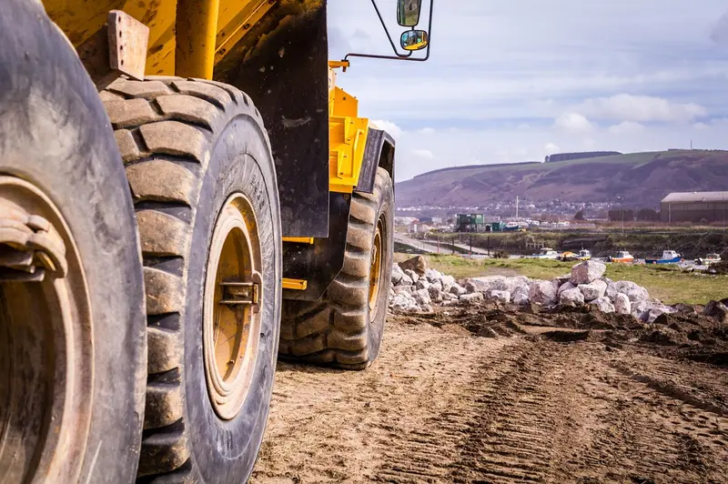Close-up of the large tires on a yellow off-highway dump truck