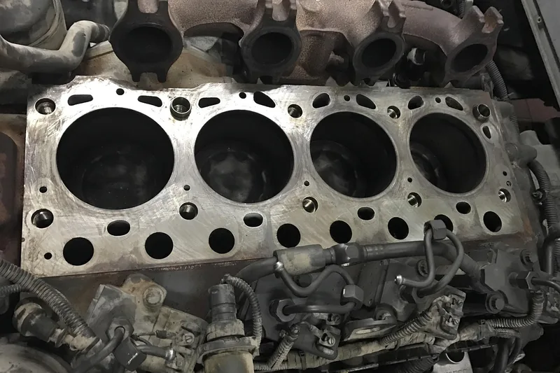 Engine block with four round cylinder bores lined up in a single row