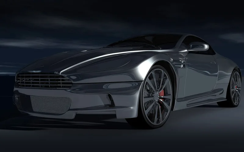 Computer rendering of a silver grand tourer coupe with a mesh grille on a dark background