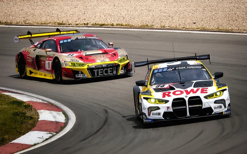 Modern race cars running side by side through a banked speedway turn Modern race cars running side by side through a banked speedway turn