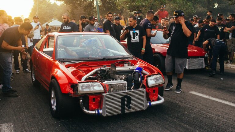A drag racing muscle car launching off the starting line, a common setting for nitrous-assisted runs