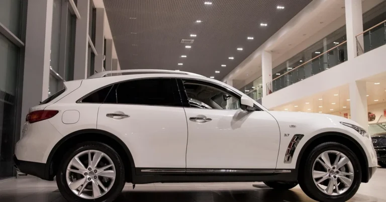 White SUV on display inside a car dealership showroom