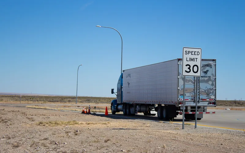 A fully loaded semi-truck can weigh up to 40 tons under federal limits Loaded semi-truck driving on a highway, illustrating heavy commercial vehicle weight