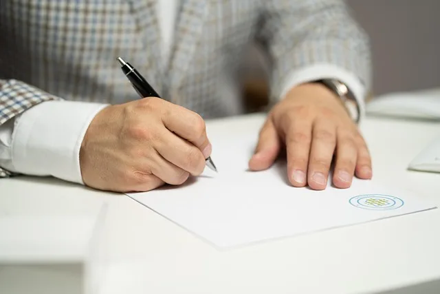Person signing car loan financing paperwork