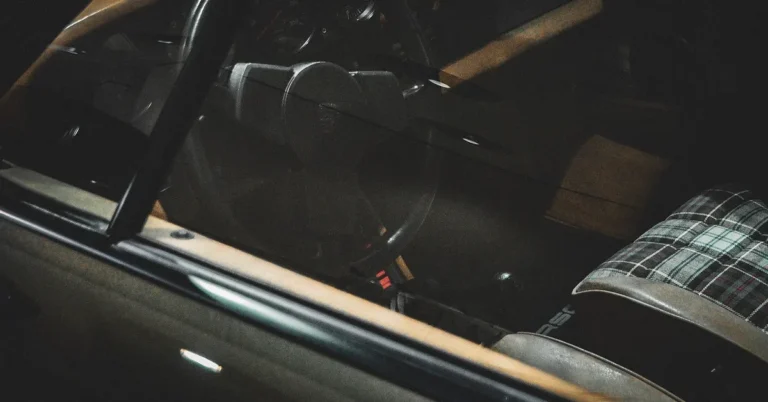 A car interior cockpit view showing the driver seat and controls