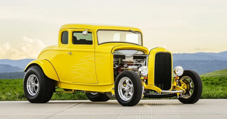 Yellow custom hot rod coupe with flame paint and chrome wheels