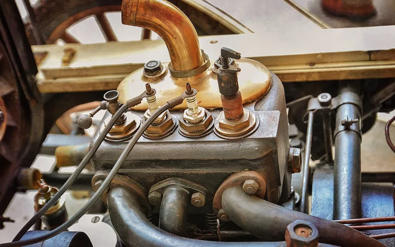 Antique engine with spark plugs and ignition wires, showing how old wiring layouts look