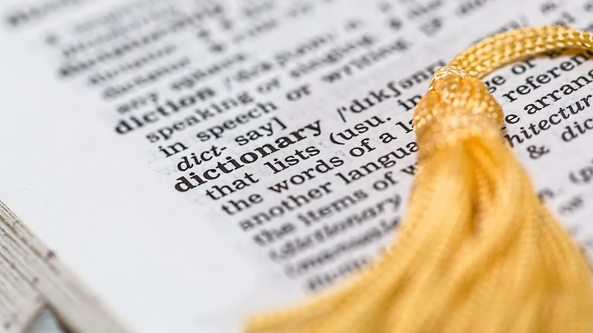 An open dictionary page showing a word definition, representing the etymology of the word auto