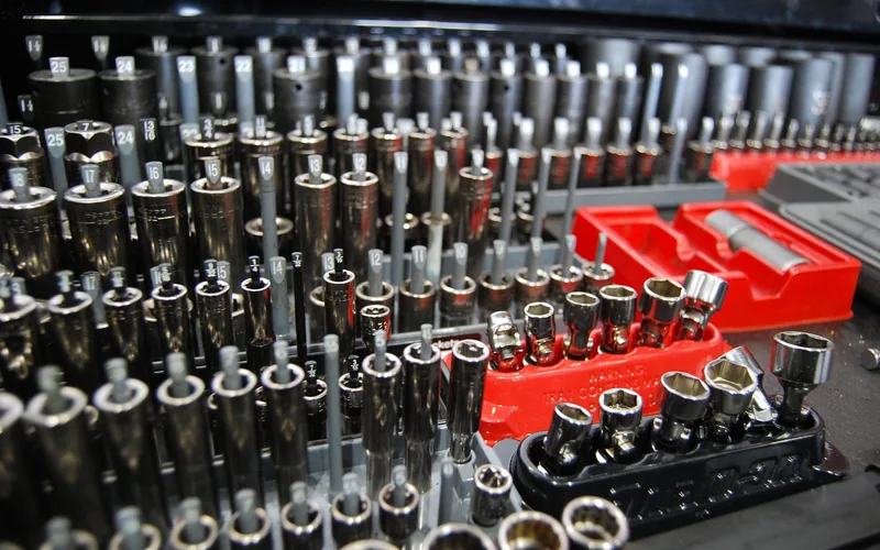 Socket wrench set laid out in an open toolbox on a workshop bench Socket wrench set laid out in an open toolbox on a workshop bench