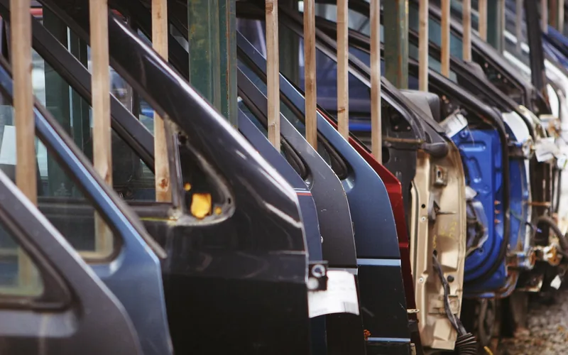 Rows of car body panels and doors at a manufacturing supply facility