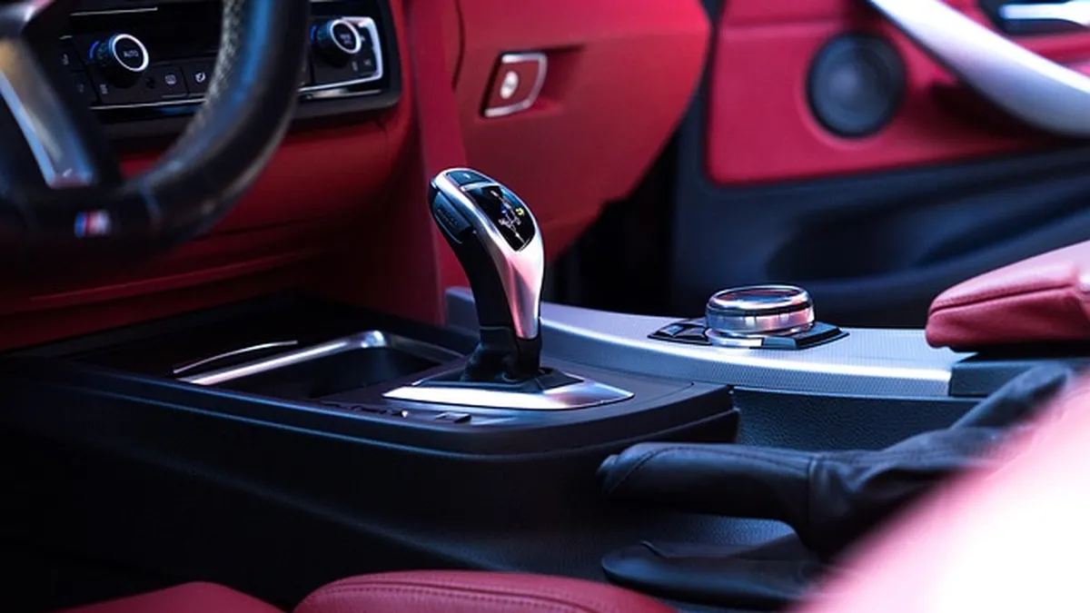 Close-up of a car center console cup holder showing typical diameter