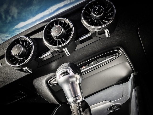 Close-up of car dashboard air vents where a rat or rodent odor can linger