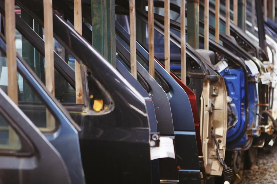 Rows of car door panels racked for assembly