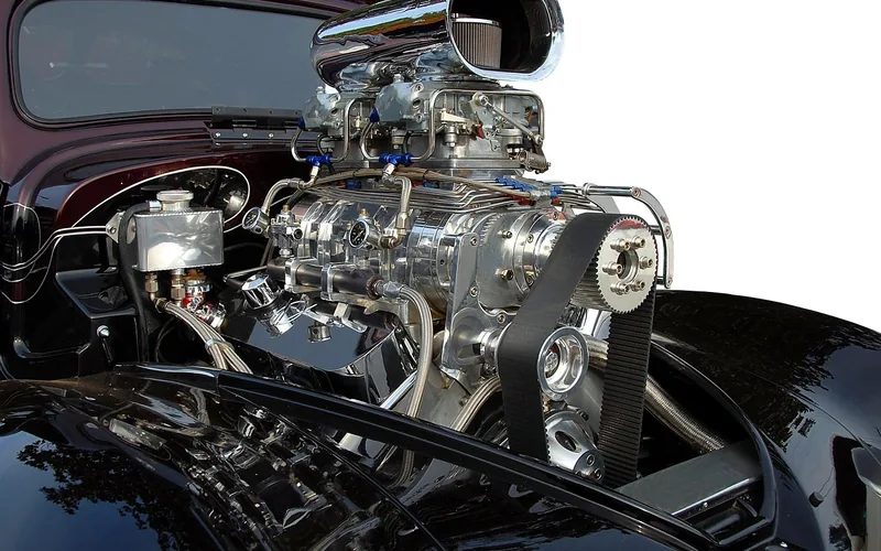 A close-up view of a car engine bay with cooling system components visible A close-up view of a car engine bay with cooling system components visible