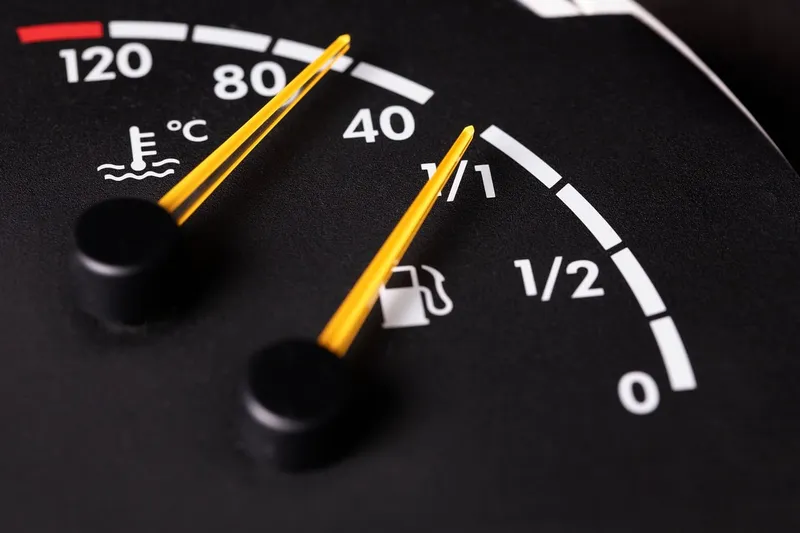 Close-up of a dashboard fuel gauge and temperature gauge