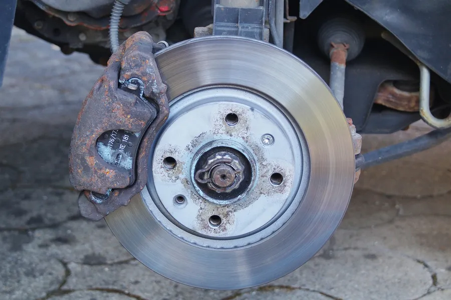 Brake rotor and caliper on a vehicle with the wheel removed