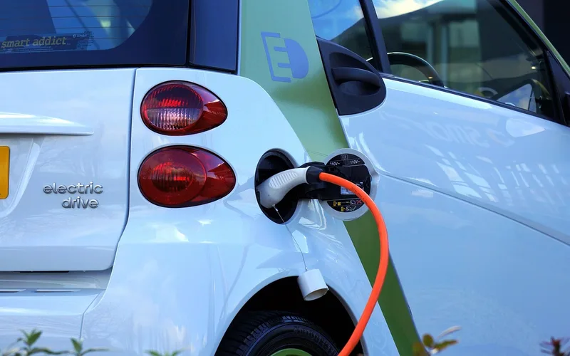 Electric vehicle charging port, representing the technology Tesla's factories are built to mass-produce
