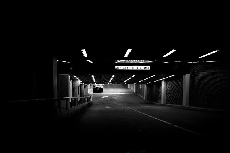 Parking garage ramp with an overhead posted clearance sign