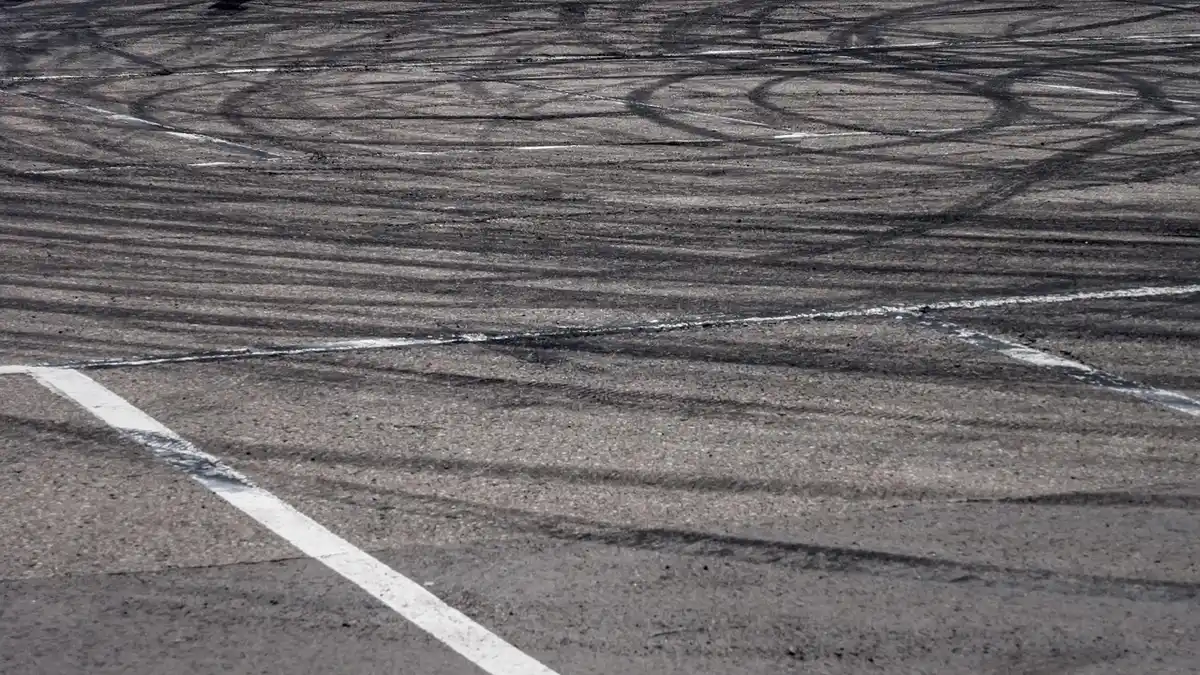 Car tires spinning and smoking during a hard turn, the moment that produces a screech or squeal sound