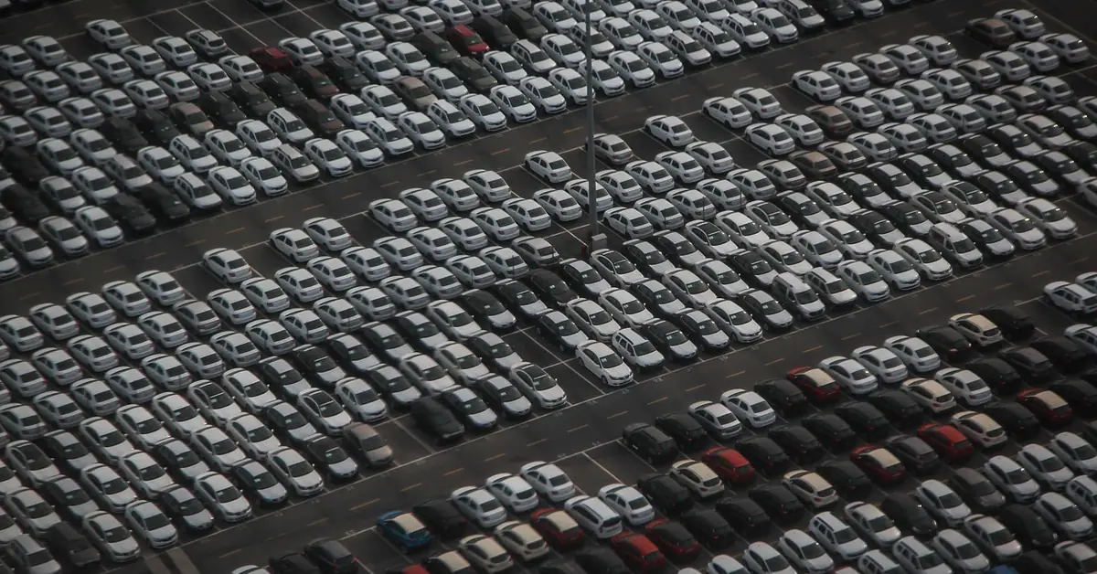 Aerial view of rows of new cars parked at a vehicle lot