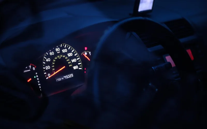 Illuminated speedometer and odometer on a car dashboard at night