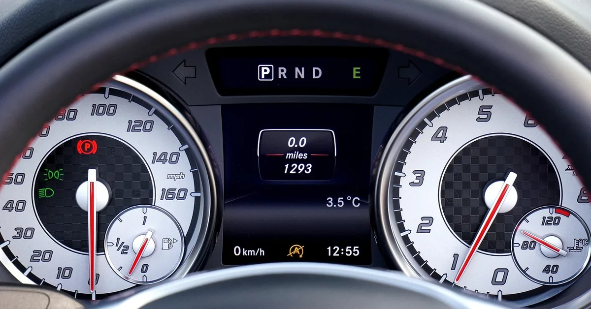 Car instrument cluster with speedometer and odometer readout in miles