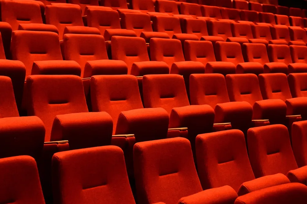 Rows of empty red cinema seats
