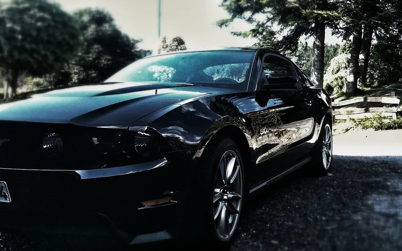 Classic first-generation Ford Mustang fastback in dark paint Classic first-generation Ford Mustang fastback in dark paint