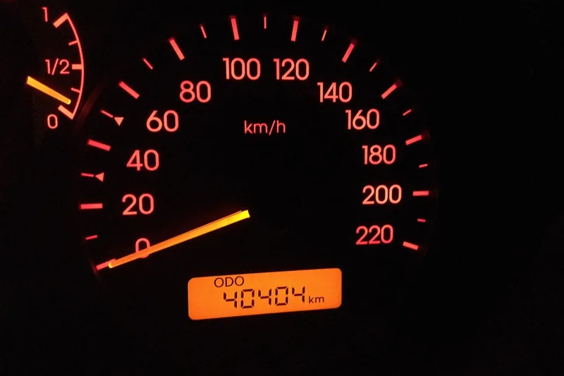 Illuminated car speedometer with the odometer display lit orange