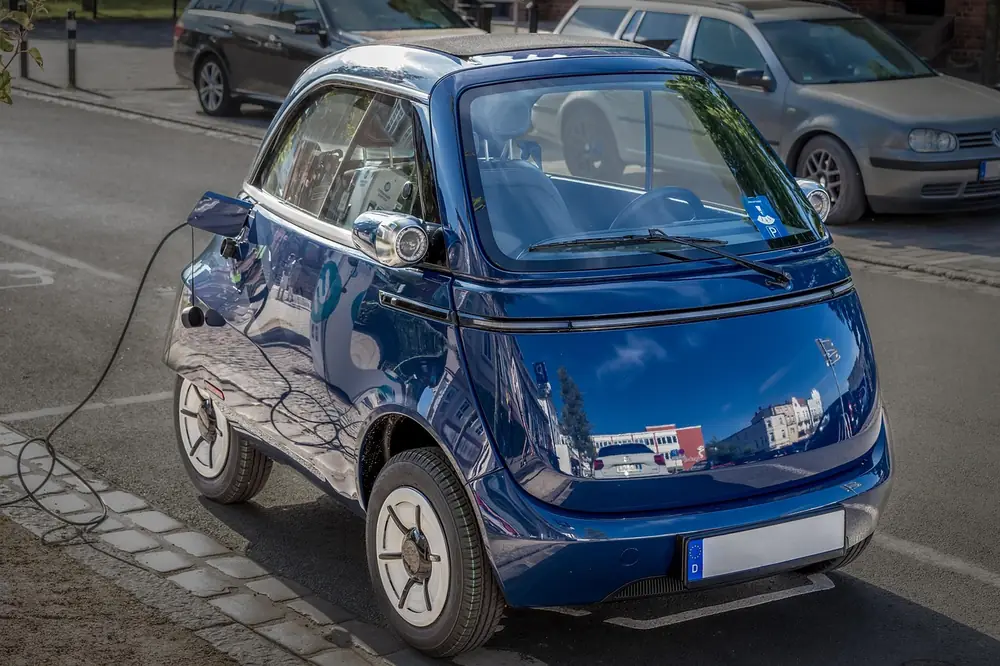 Small subcompact economy car parked in a city street