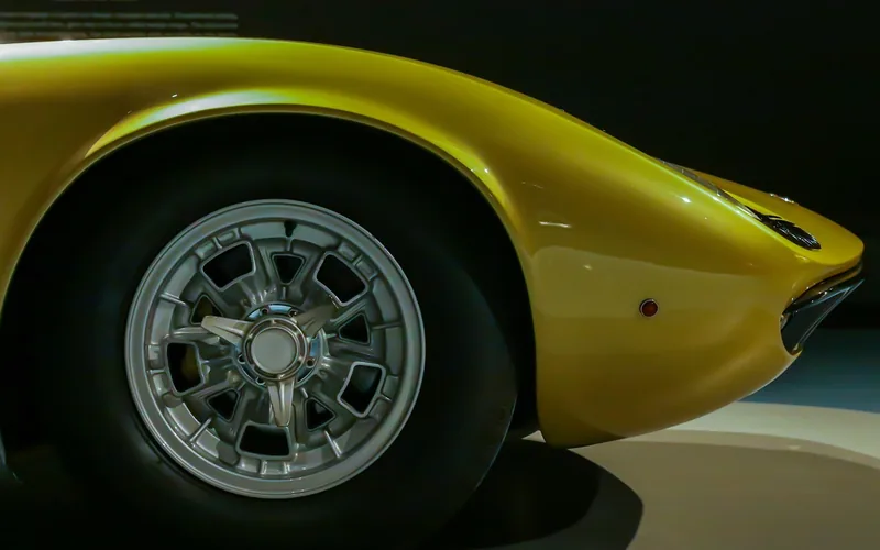 Yellow 1966 Lamborghini Miura front wheel arch and headlight on museum display