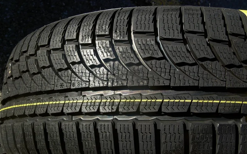 Close-up of a tire tread showing tread blocks and grooves Close-up of a tire tread showing tread blocks and grooves