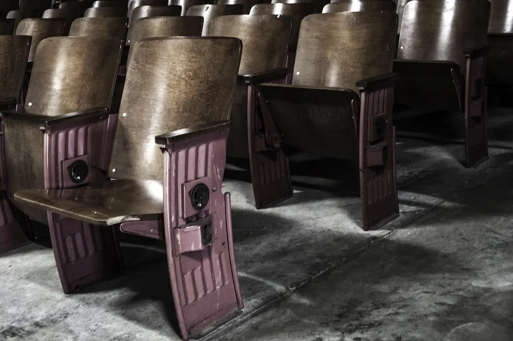 Rows of old wooden cinema seats