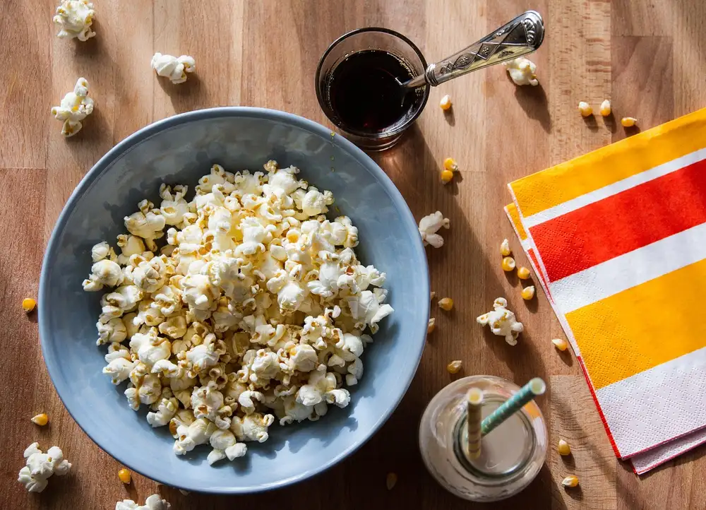 Bowl of popcorn on a wooden table for a movie night