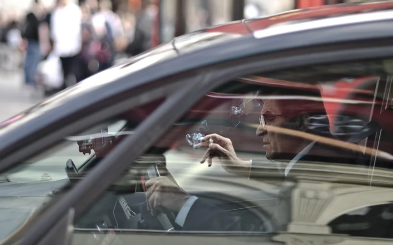 Rideshare driver in a car on a city street