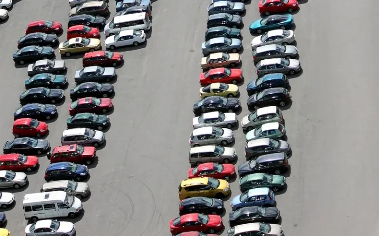 Rows of parked cars in a large parking lot seen from above