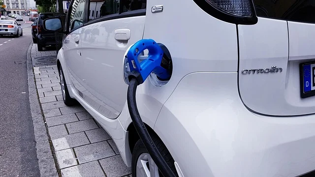 Electric car plugged into a charging station cable