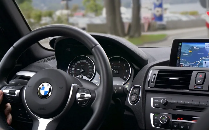 Car dashboard GPS navigation system showing a turn-by-turn route on screen