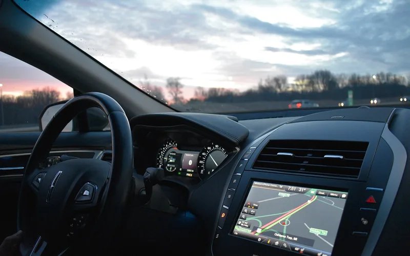 smartphone GPS navigation app mounted on a car dashboard showing real-time location smartphone GPS navigation app mounted on a car dashboard showing real-time location