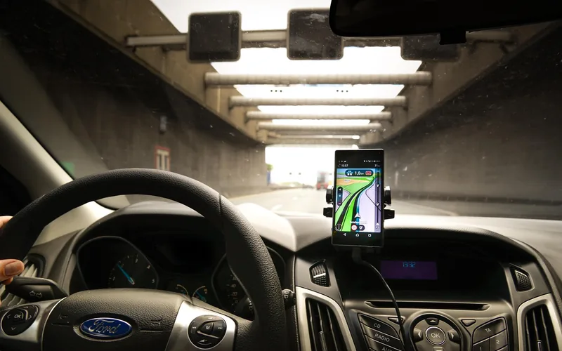 smartphone mounted on car dashboard for hands-free Bluetooth audio and navigation