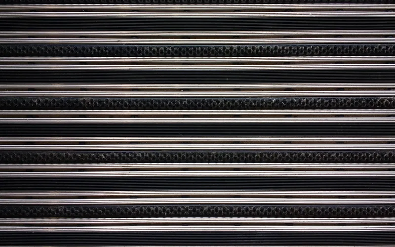 Textured rubber cargo mat material Close-up of textured black rubber matting material used in anti-slip cargo liners