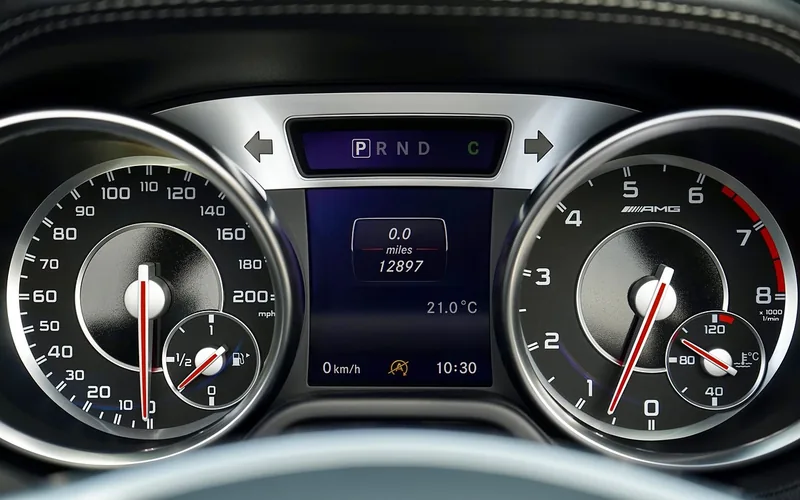 car dashboard tachometer and speedometer showing rpm and power gauge