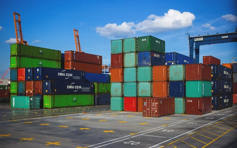 shipping containers stacked at a port used for vehicle export