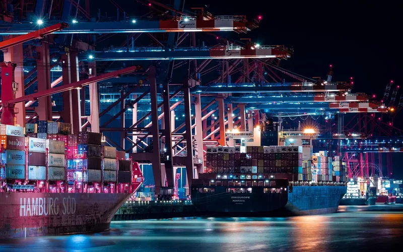 Shipping containers loaded onto a cargo ship at a port dock for export