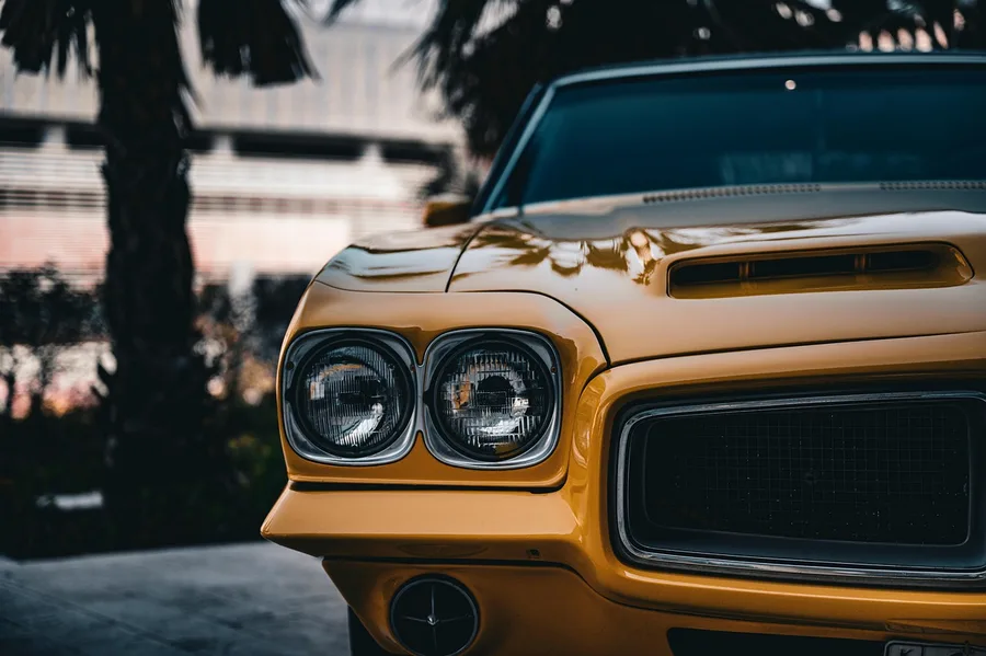 Front end of a classic yellow American muscle car