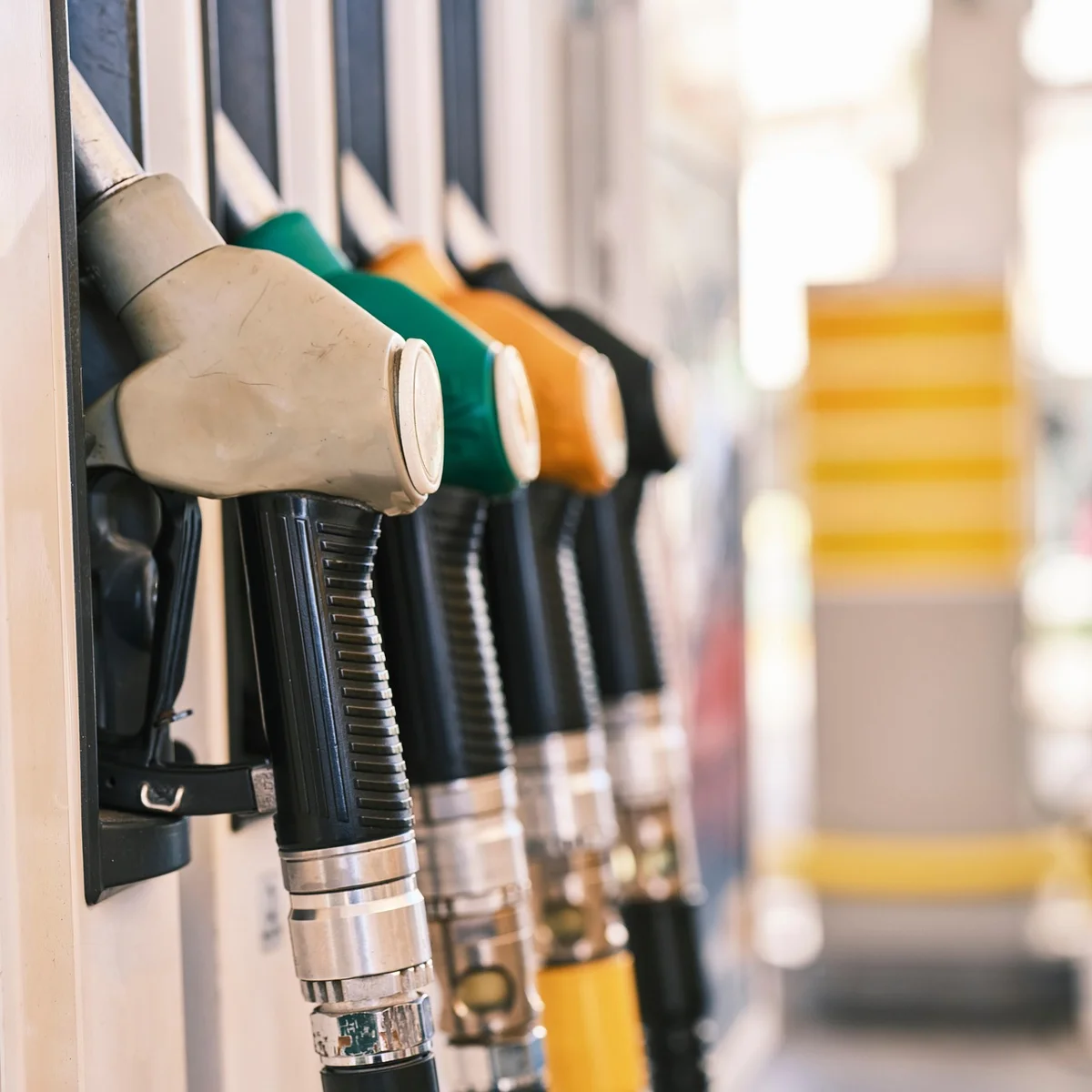 Driver refueling a car with Unleaded 88 gasoline