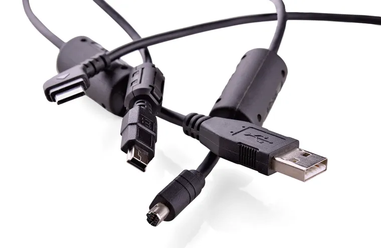 Several black device cables with USB and other connectors on a white background