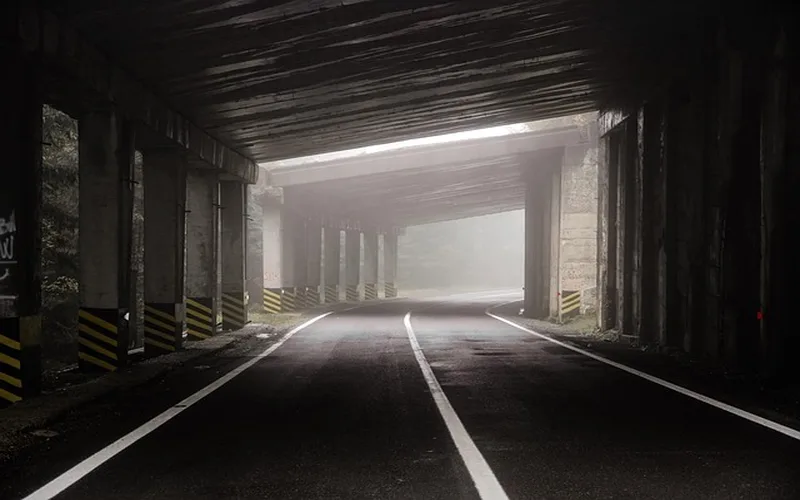 Foggy tunnel road at night