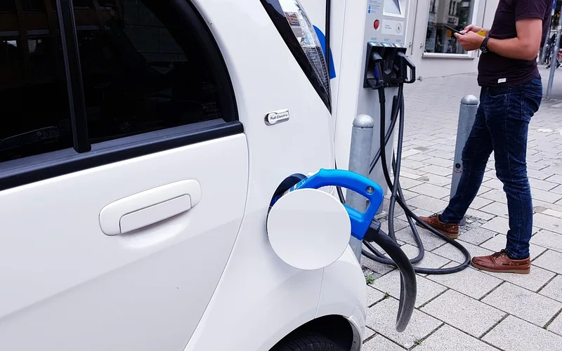 Electric car plugged into a home charging station terminal